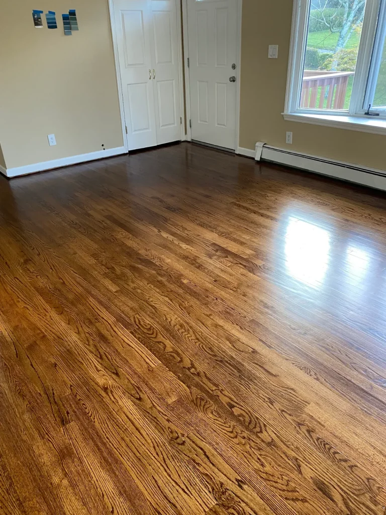 Refinished oak floor with a dark stain near an entry door